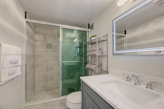 a bathroom with a sink toilet and shower