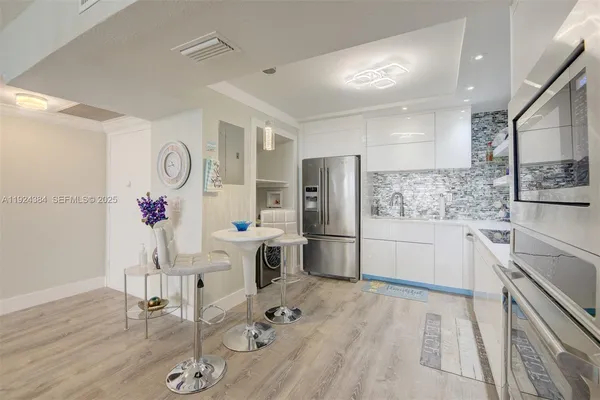 a kitchen with stainless steel appliances granite countertop a refrigerator and a stove top oven