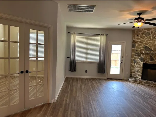 wooden floor in an empty room with a window