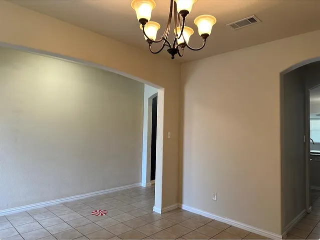 a view of a chandelier fan and wooden floor