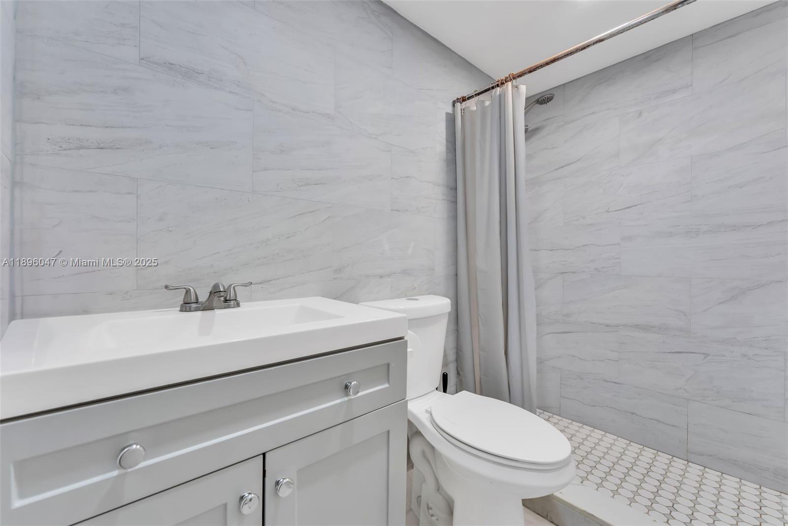 Hialeah Hialeah, FL 33012 - Photo 2 of 9 a bathroom with a sink a toilet and shower