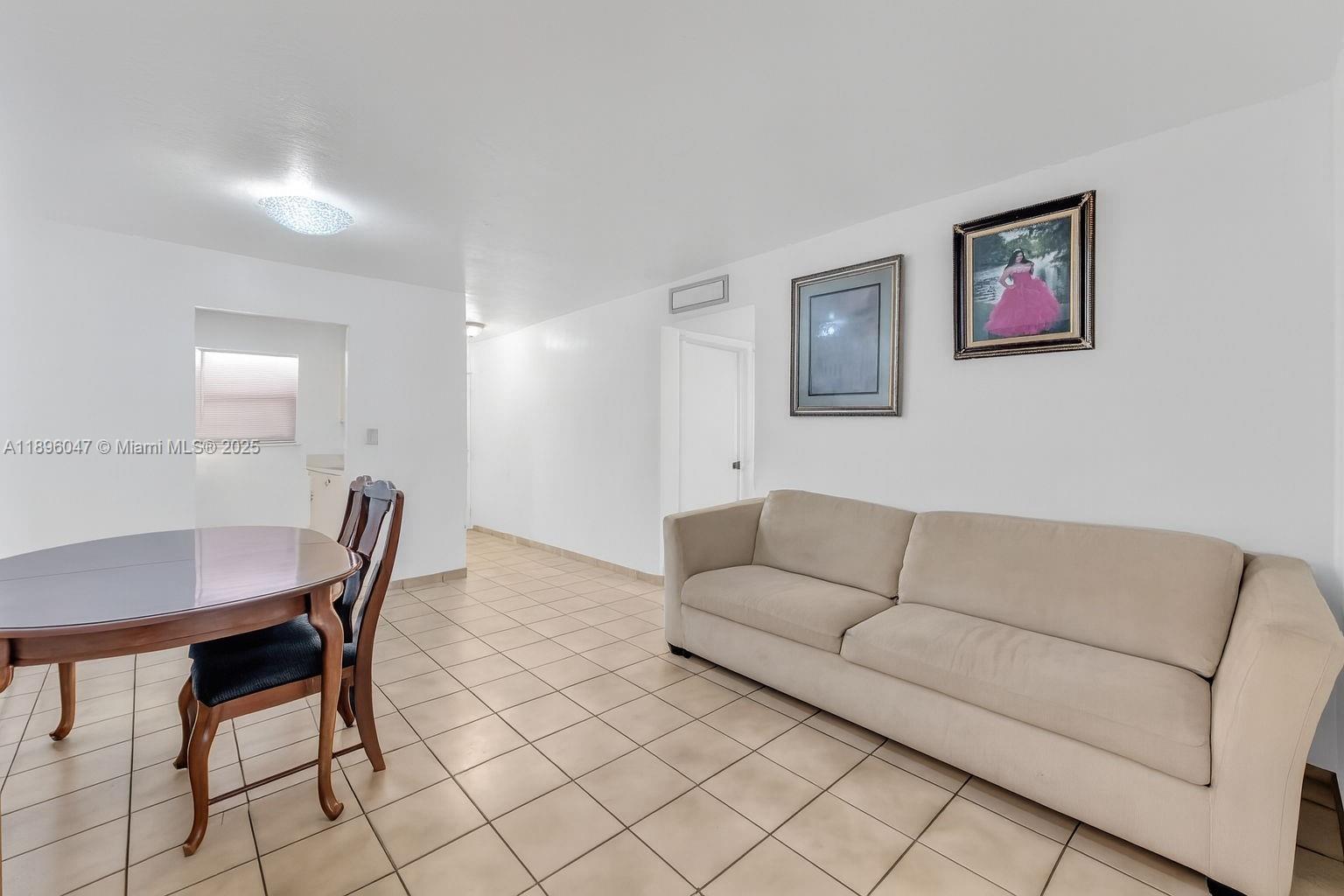 Hialeah Hialeah, FL 33012 - Photo 4 of 9 a living room with furniture a dining table and a refrigerator