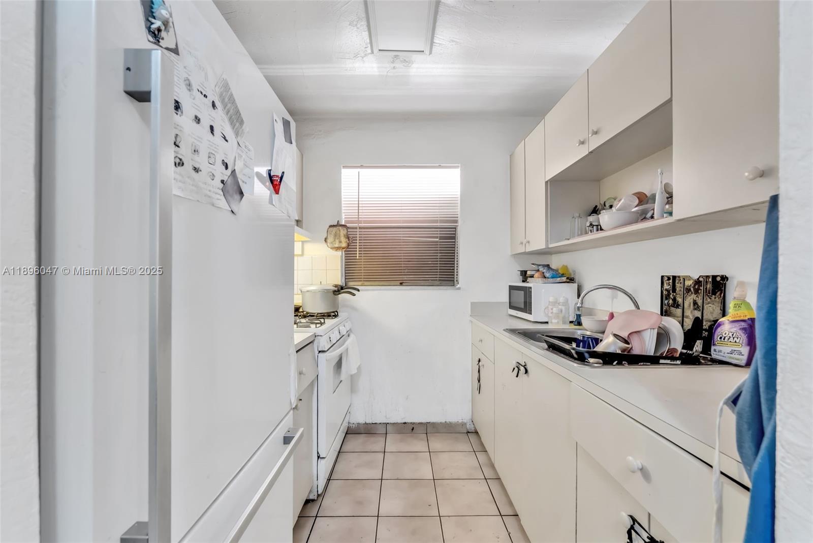 Hialeah Hialeah, FL 33012 - Photo 6 of 9 a kitchen with a refrigerator and cabinets