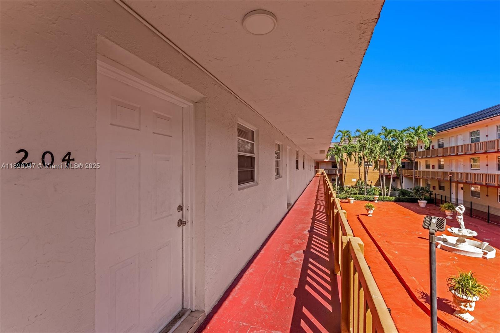Hialeah Hialeah, FL 33012 - Photo 8 of 9 a balcony with wide window and wooden floor