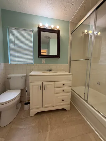 a bathroom with a toilet sink and a mirror