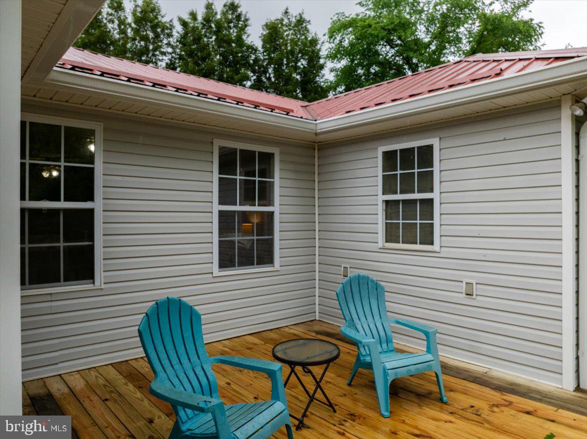 11419 Oak Grove Road Bristol, VA 24202 - Photo 26 of 36 a view of a chair and table in the back yard of the house