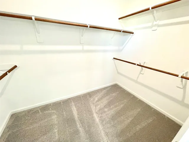 a large white kitchen with cabinets
