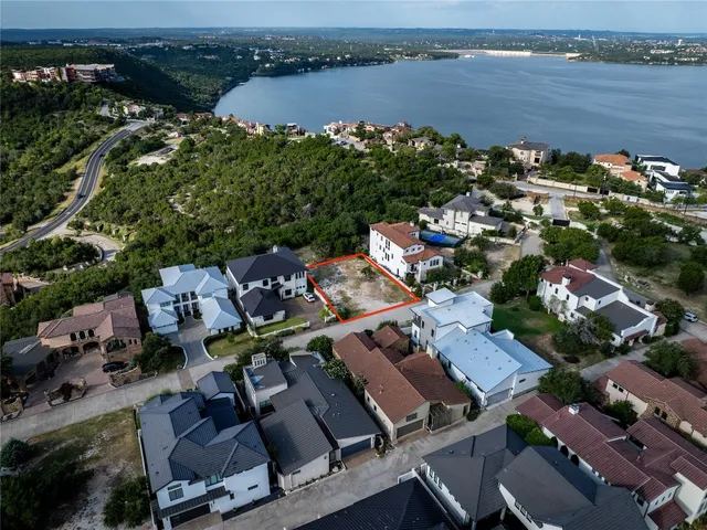 an aerial view of a house with outdoor space and lake view