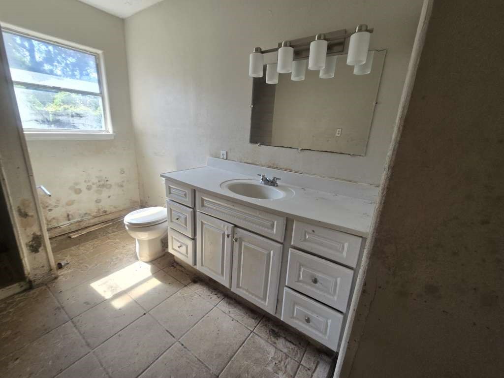 424 County Road 140 Liberty, TX 77575 - Photo 3 of 12 a bathroom with a toilet sink and mirror