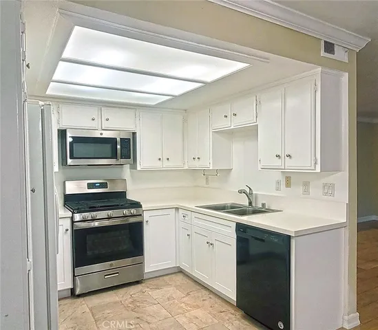 a kitchen with a sink stove and microwave