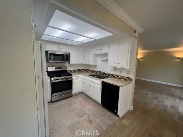 a view of an empty room with glass door and windows