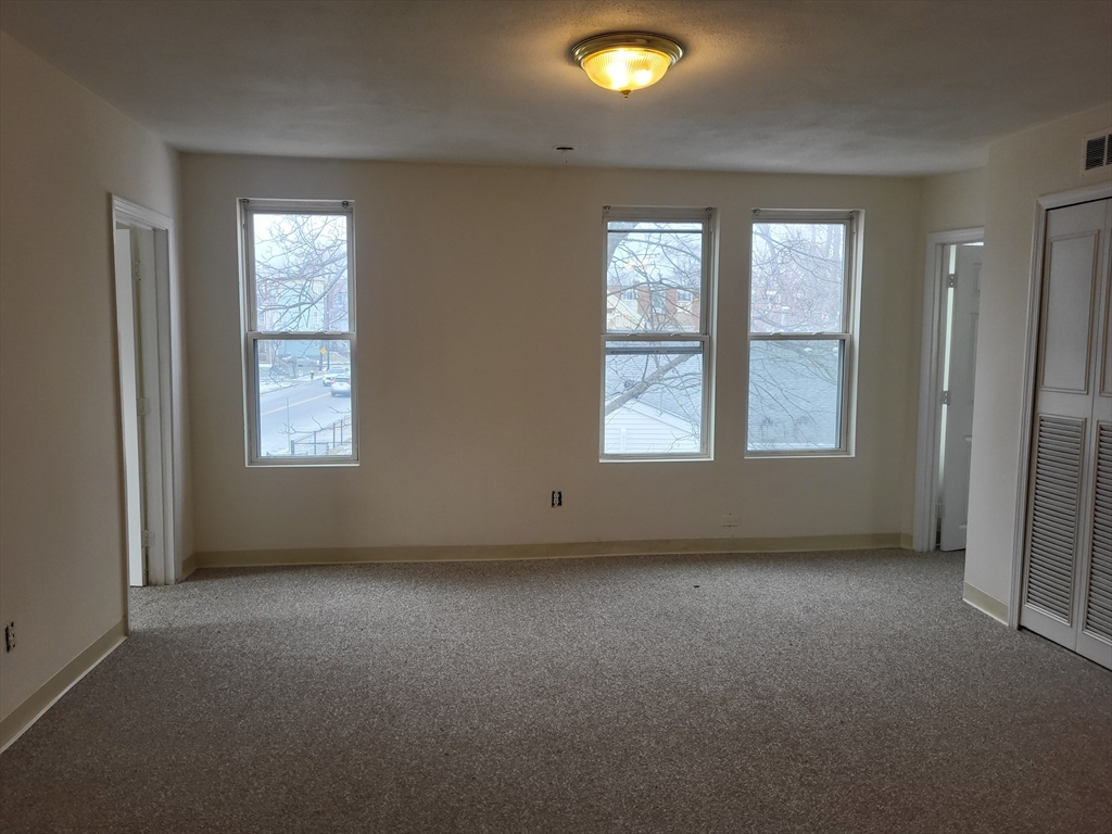 947 River Street, Unit 6 Boston, MA 02136 - Photo 1 of 8 an empty room with windows