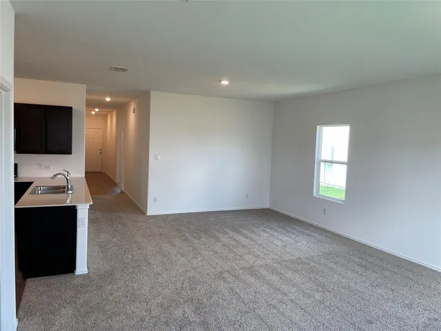 a kitchen with wooden cabinets and black appliances