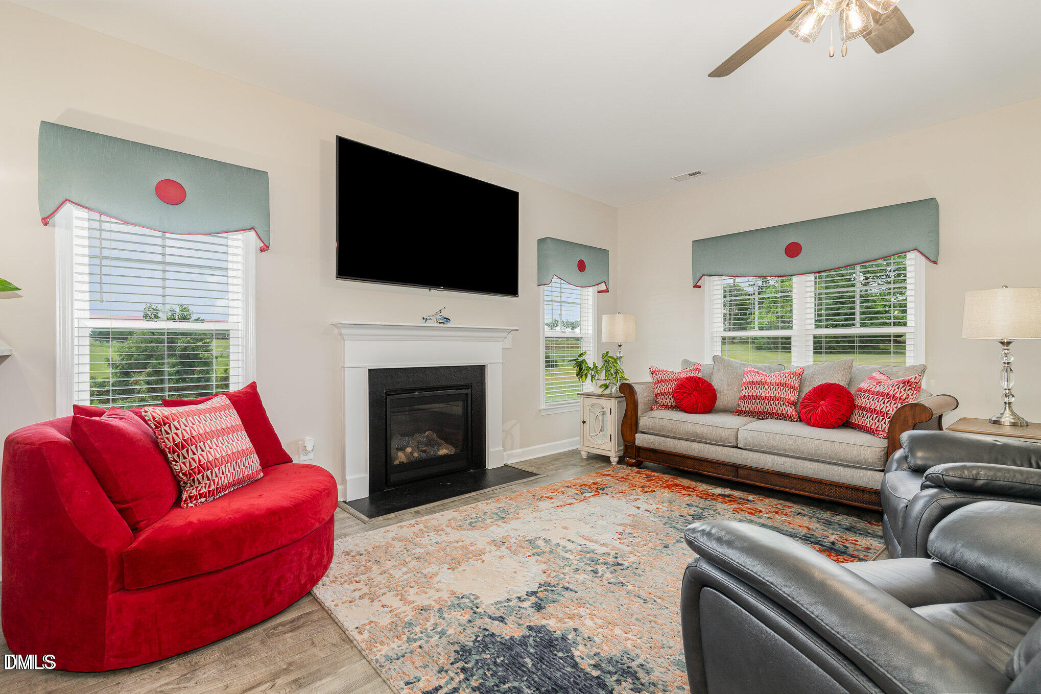 8662 Buckhorn Plantation Road Sims, NC 27880 - Photo 15 of 37 a living room with furniture a flat screen tv and a fireplace