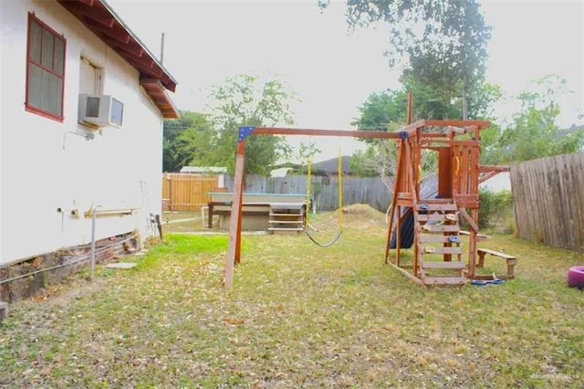 a view of a house with a backyard