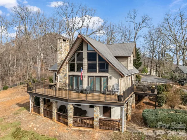 a roof deck with table and chairs under an umbrella