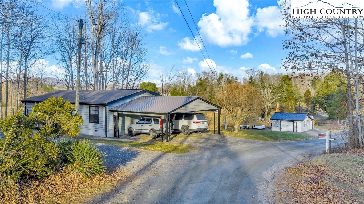 747 Nathans Creek School Road Crumpler, NC 28617 - Photo 1 of 42 a front view of a house with a yard table and chairs