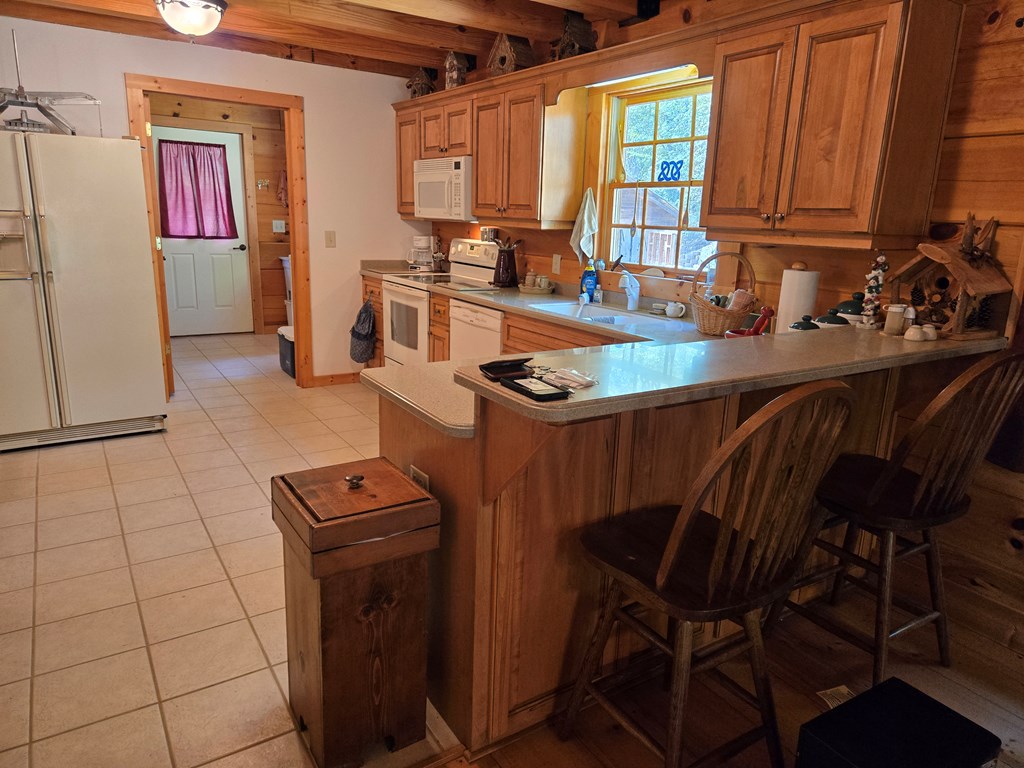 586 Laurel Haven Road Hayesville, NC 28904 - Photo 16 of 34 a kitchen with a sink a stove and a refrigerator
