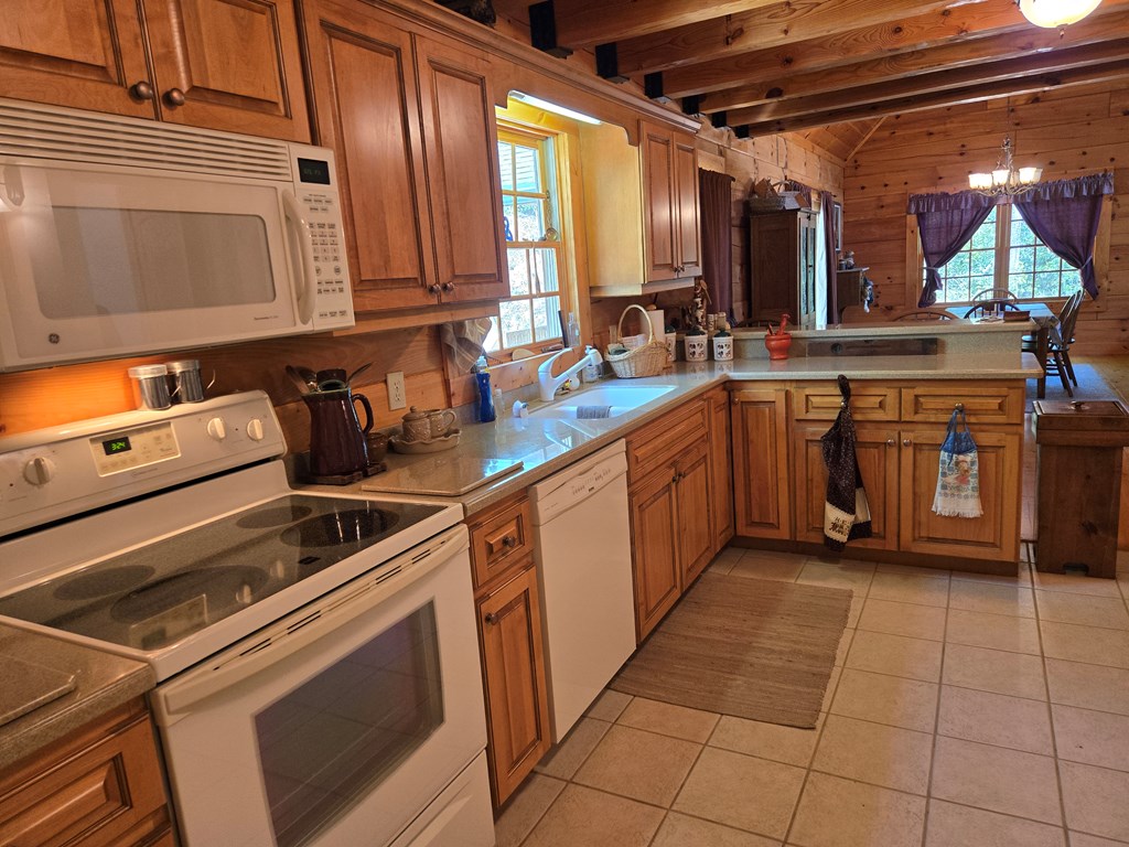 586 Laurel Haven Road Hayesville, NC 28904 - Photo 17 of 34 a kitchen with stainless steel appliances granite countertop a sink and cabinets