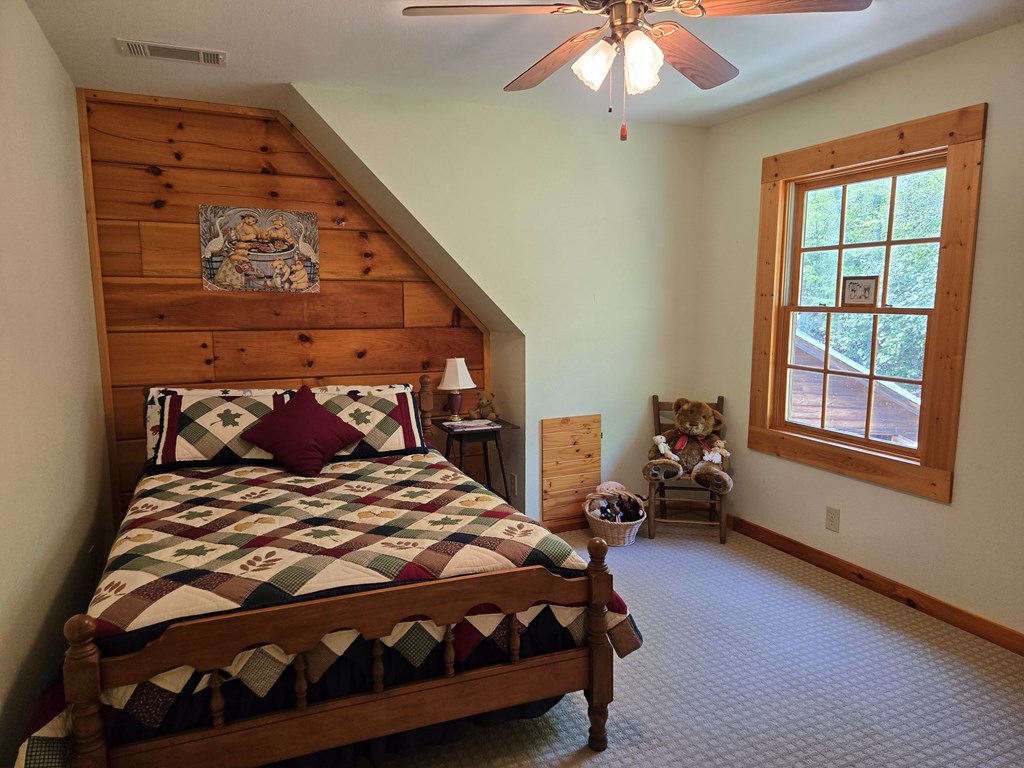 586 Laurel Haven Road Hayesville, NC 28904 - Photo 31 of 34 a bedroom with a bed and a chandelier