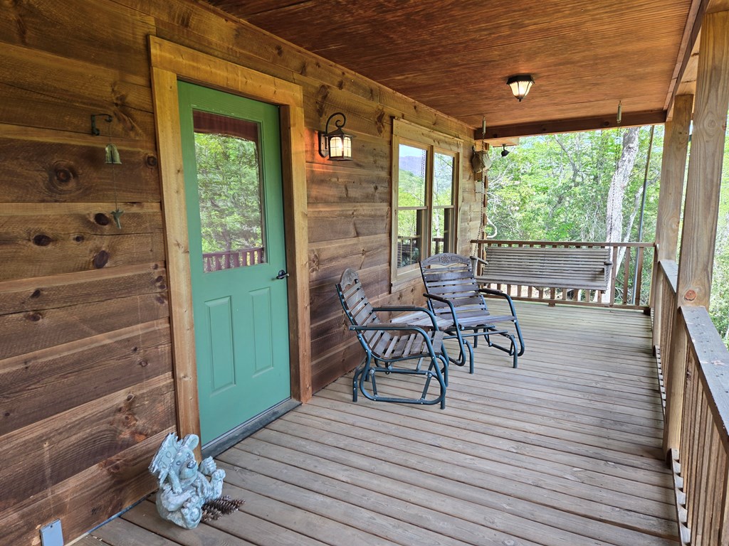 586 Laurel Haven Road Hayesville, NC 28904 - Photo 6 of 34 a view of a patio with table and chairs and wooden floor