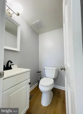 a white toilet sitting next to a bathroom sink
