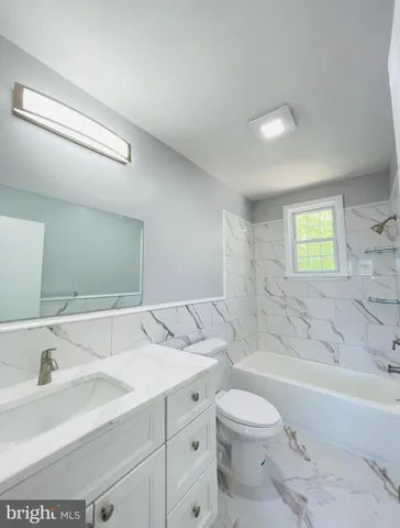 a bathroom with a sink a toilet and bathtub