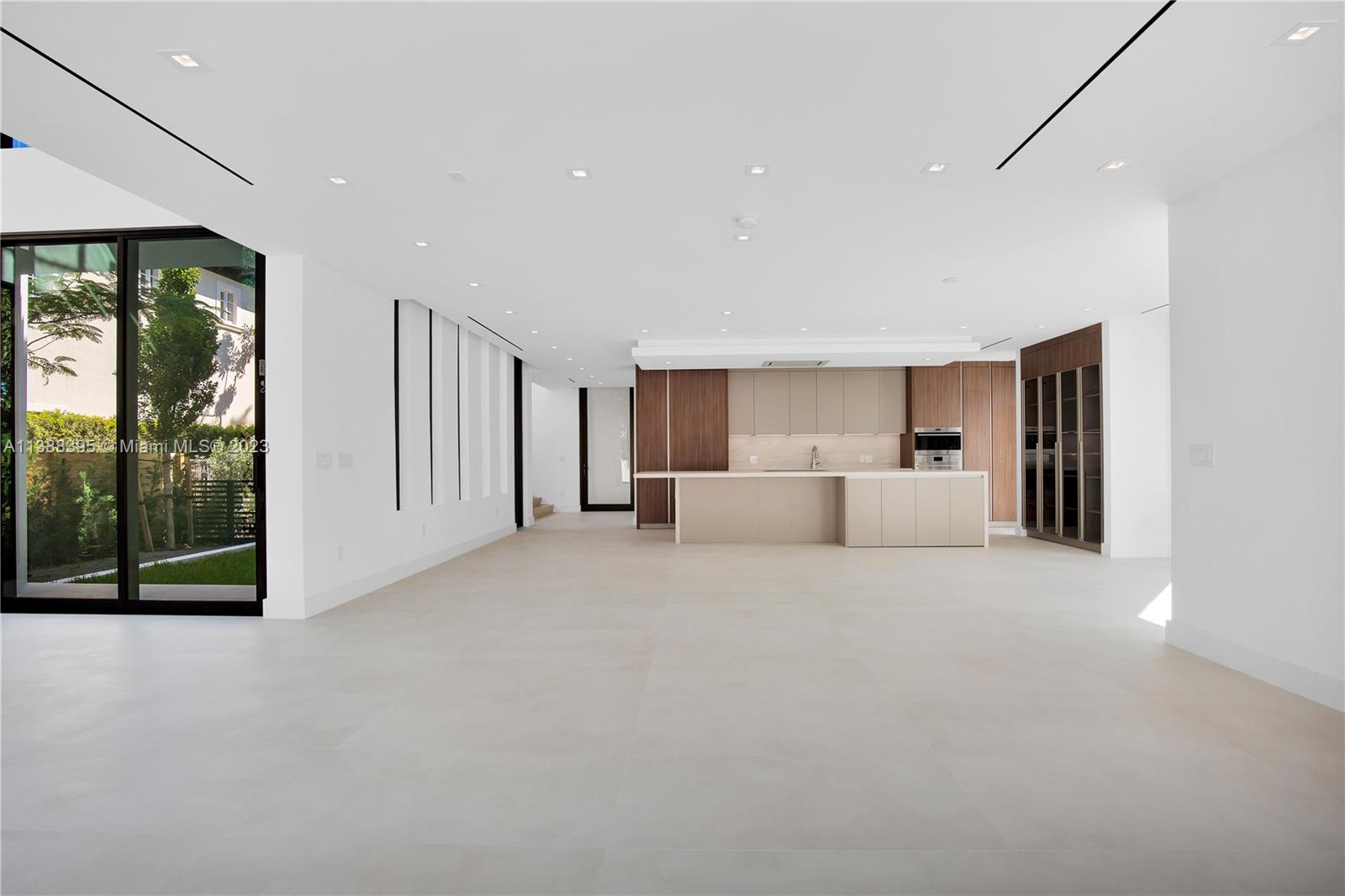 5630 Pine Tree Drive Miami Beach, FL 33140 - Photo 11 of 32 a view of a livingroom with furniture and floor to ceiling window