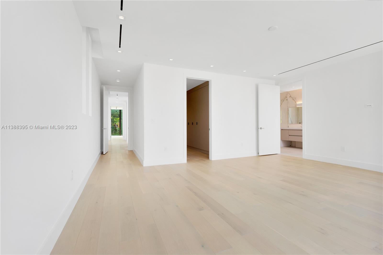 5630 Pine Tree Drive Miami Beach, FL 33140 - Photo 17 of 32 an empty room with closet and windows