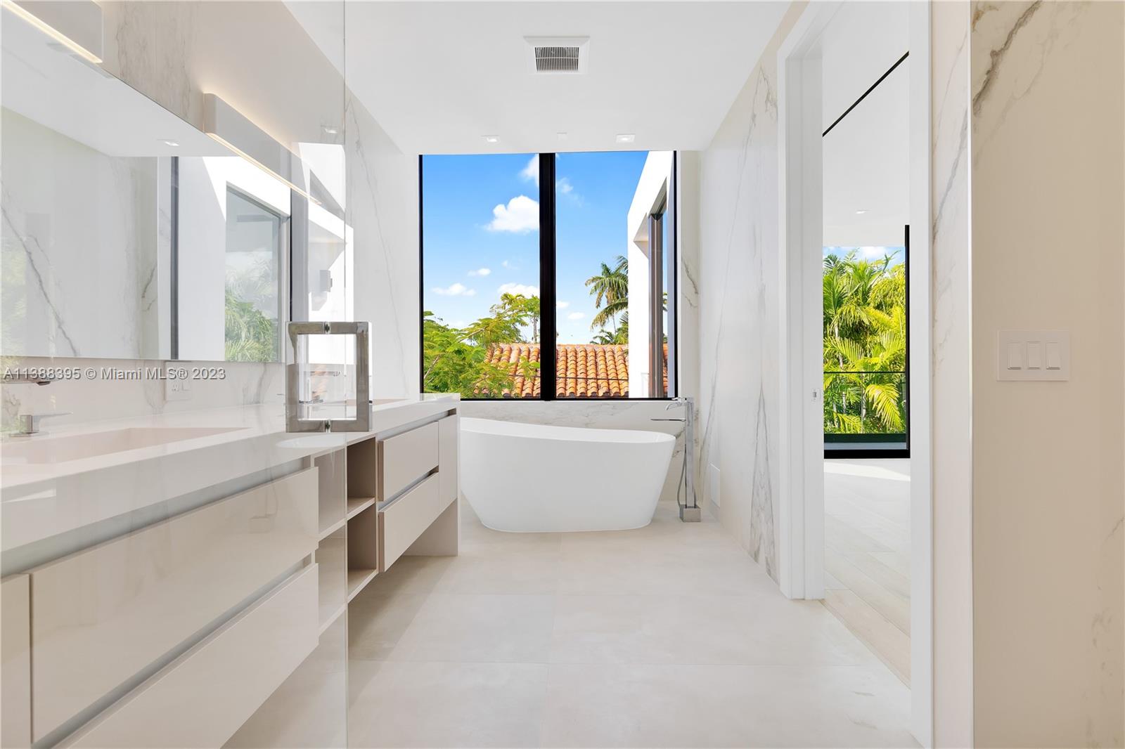 5630 Pine Tree Drive Miami Beach, FL 33140 - Photo 22 of 32 a bathroom with a bathtub sink and mirror