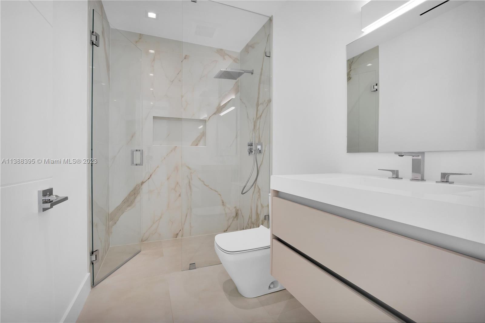 5630 Pine Tree Drive Miami Beach, FL 33140 - Photo 25 of 32 a bathroom with a sink a toilet and shower