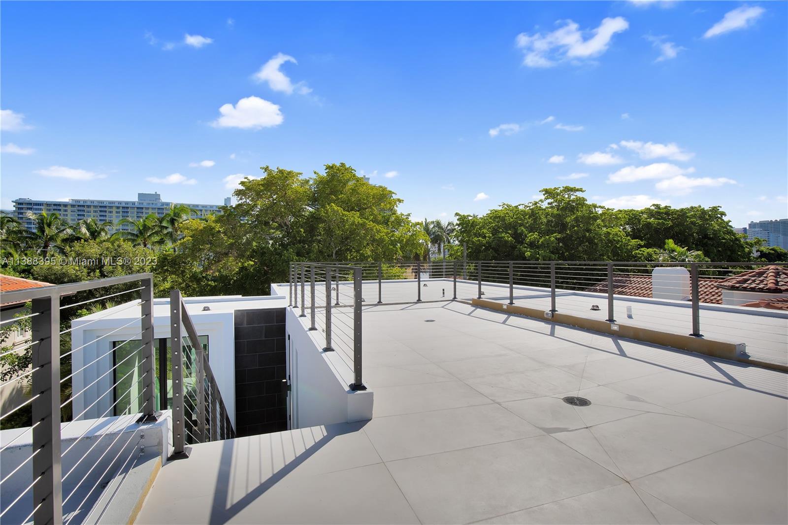 5630 Pine Tree Drive Miami Beach, FL 33140 - Photo 29 of 32 a view of roof deck with furniture and trees