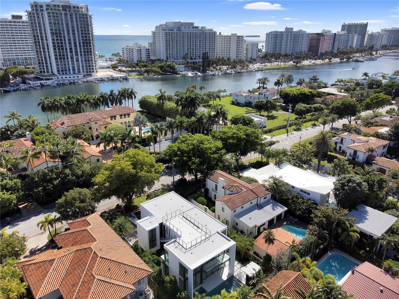 5630 Pine Tree Drive Miami Beach, FL 33140 - Photo 32 of 32 an aerial view of a city with lots of residential buildings ocean and mountain view in back