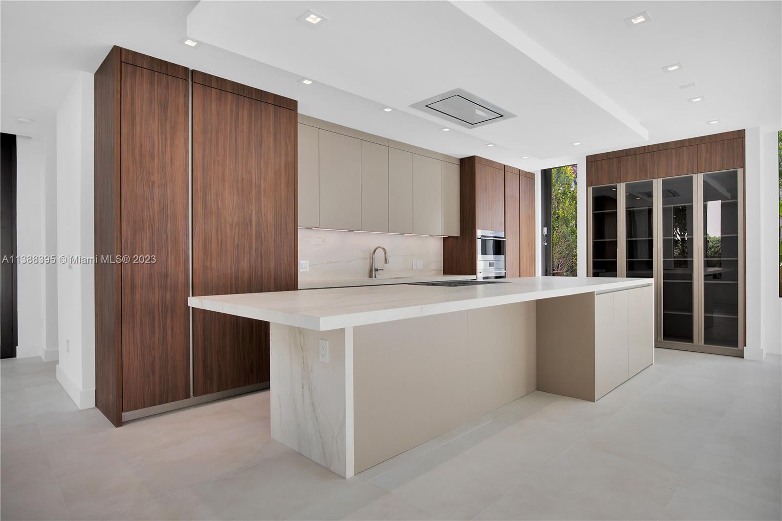 5630 Pine Tree Drive Miami Beach, FL 33140 - Photo 8 of 32 a room with cabinets and large window