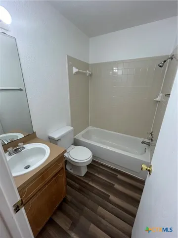 a bathroom with a sink a toilet and a bathtub