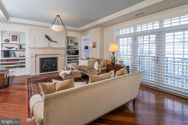 a living room with furniture window and fireplace