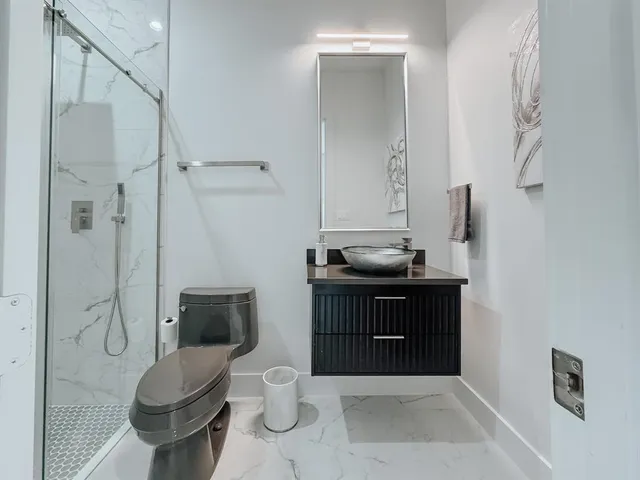 a bathroom with a sink toilet and shower
