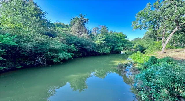 a view of a lake with huge green field