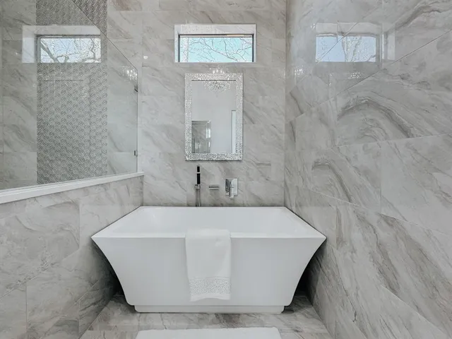 a white bath tub sitting in a bathroom