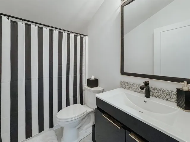 a bathroom with a sink a toilet and mirror