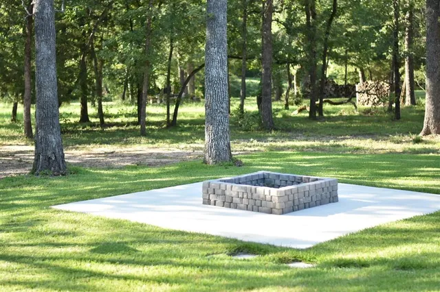 a garden with trees in the background