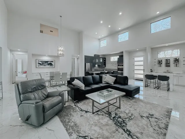 a living room with furniture wooden floor and a view of kitchen