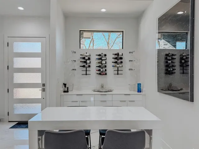 a kitchen with a table chairs sink and cabinets