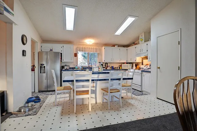 a view of a backyard with furniture and a yard
