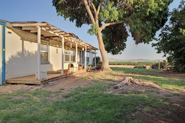 an aerial view of a house with a yard and lake view