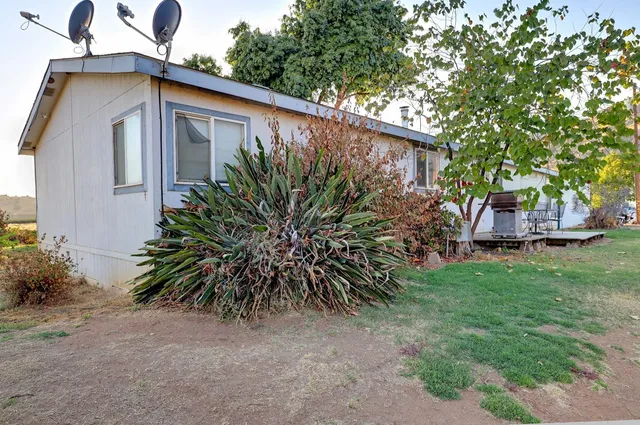 a aerial view of a house with yard and garage