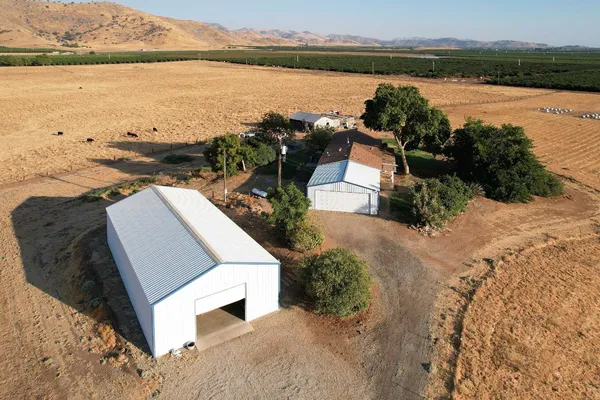 a view of a house with backyard and deck