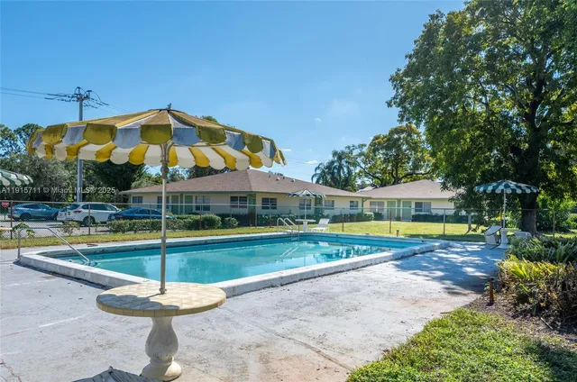 a view of a swimming pool with a yard and swimming pool
