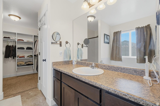 592 West 650 South Springville, UT 84663 - Photo 16 of 33 Bathroom vanity featuring a single basin sink, laminate countertop, and dark wood cabinetry
