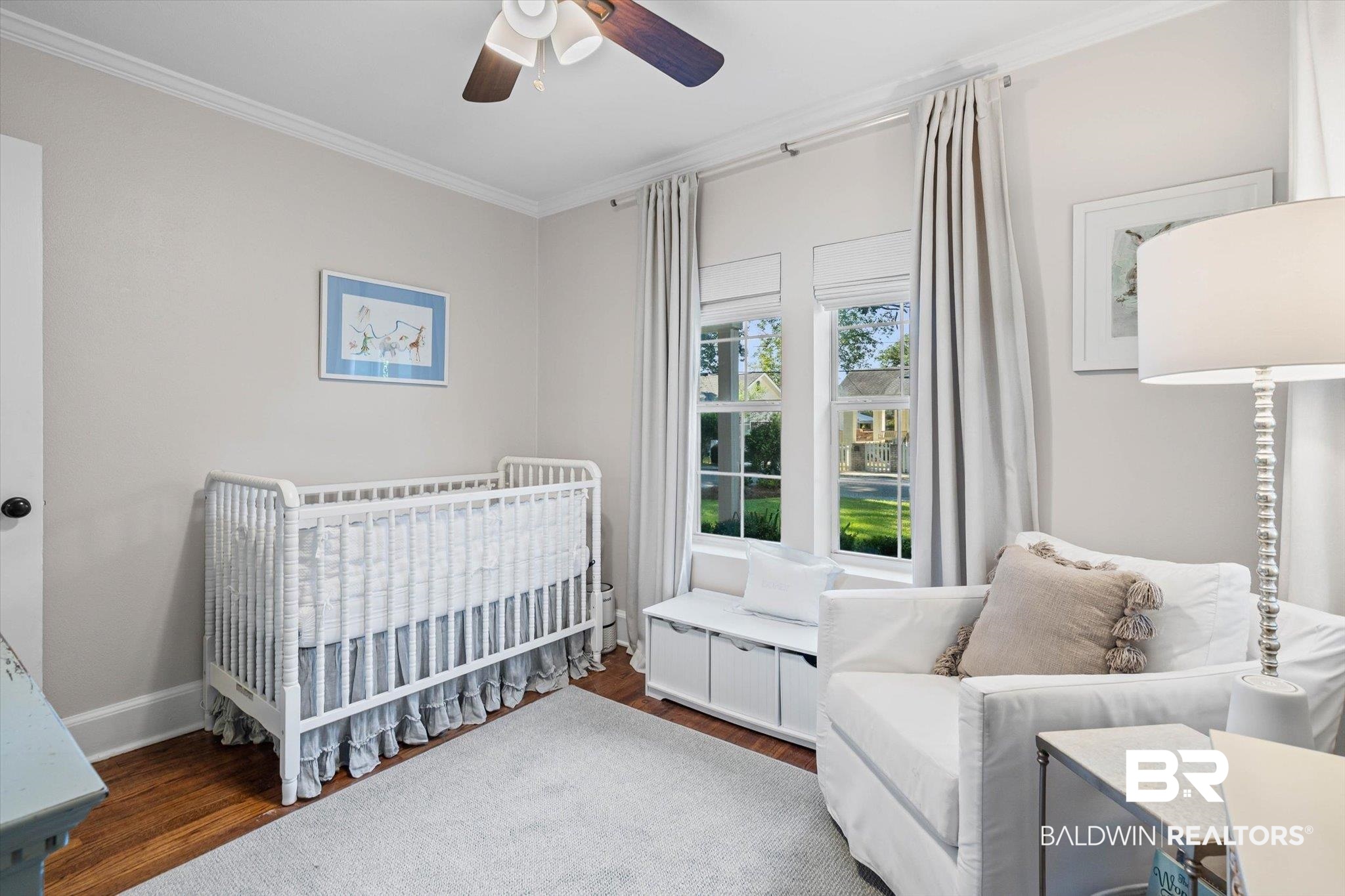 4310 The Cedars Avenue Mobile, AL 36608 - Photo 19 of 32 Bedroom featuring dark wood-style floors, crown molding, a nursery area, and a ceiling fan